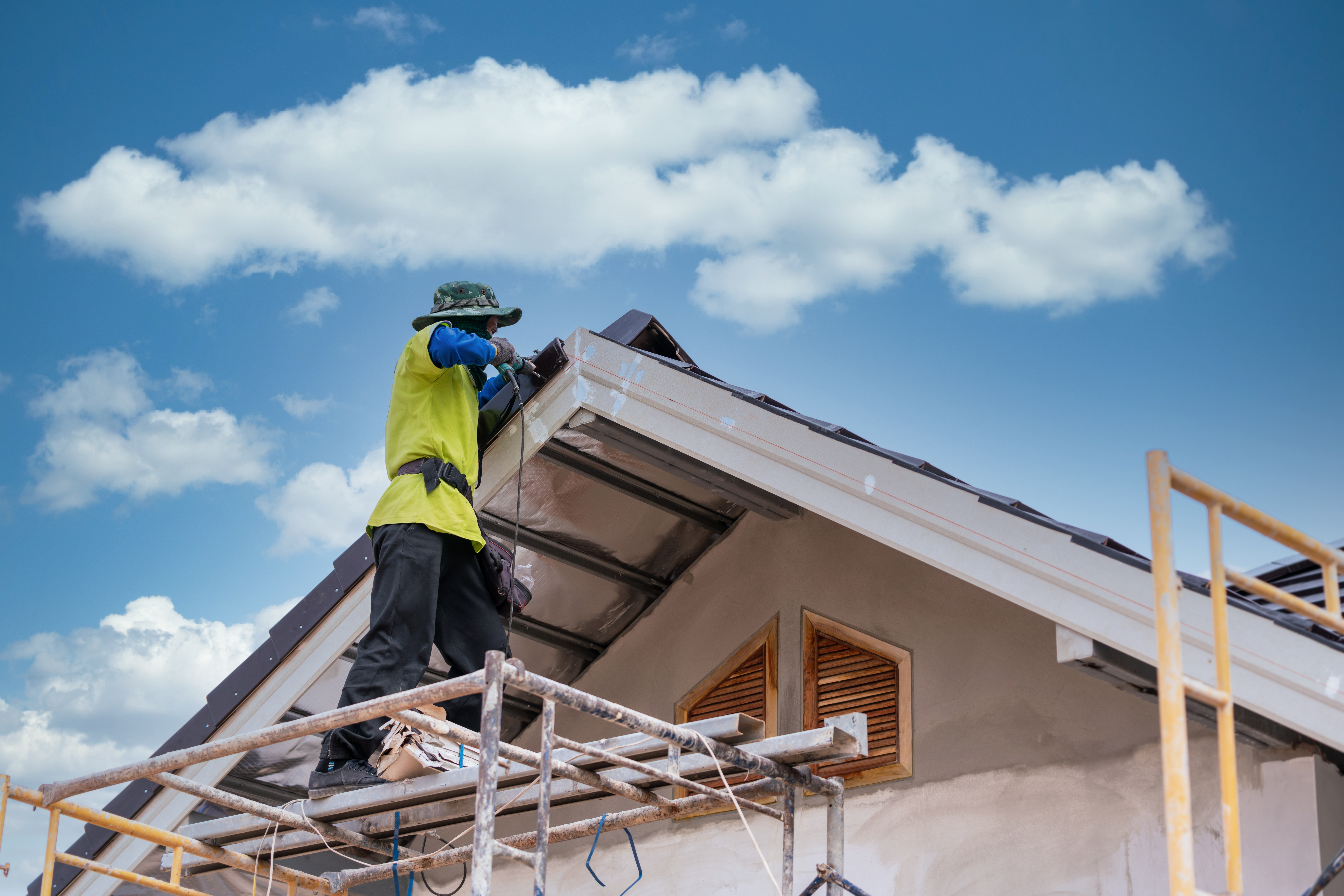 construction worker install new ceramic tile roof