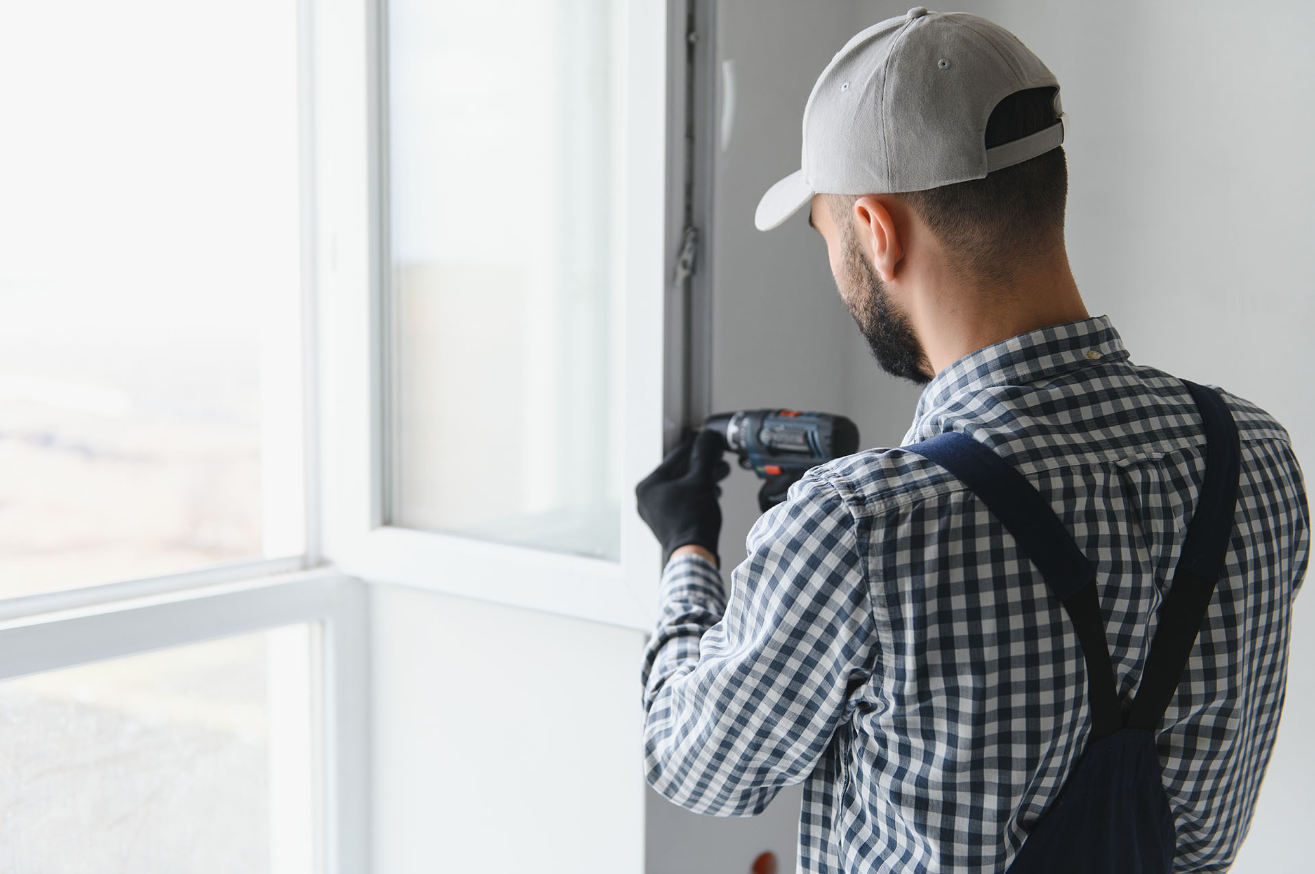 construction worker installing window house